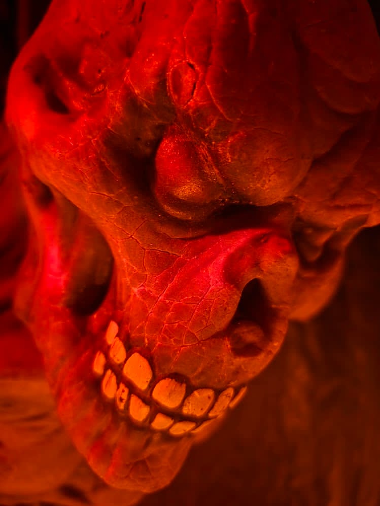 Close-up of a blood-red lit skull at The Carver's Curse haunted house in Brooklyn, Connecticut.